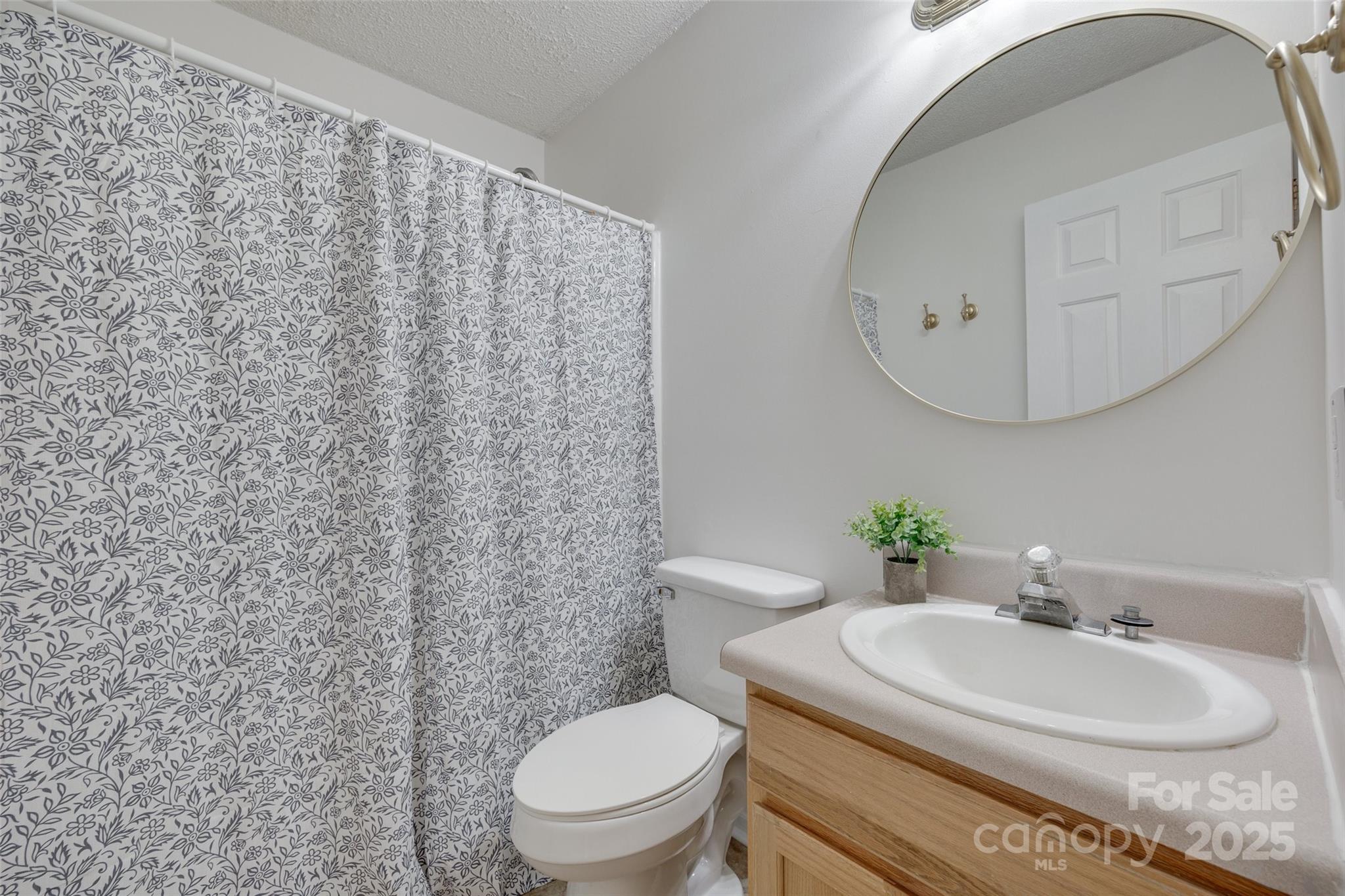 110 8th Street York, SC 29745 - Photo 15 of 26 a bathroom with a toilet sink and mirror