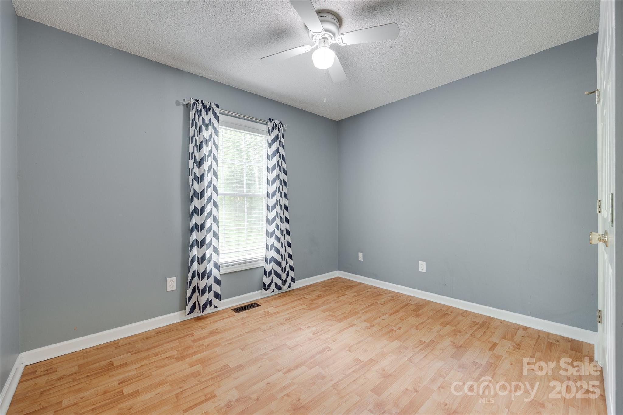 110 8th Street York, SC 29745 - Photo 18 of 26 an empty room with a window and ceiling fan