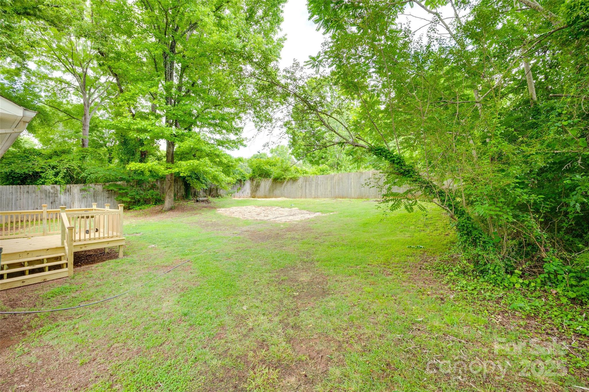 110 8th Street York, SC 29745 - Photo 22 of 26 a view of a backyard with lawn chairs and a large tree