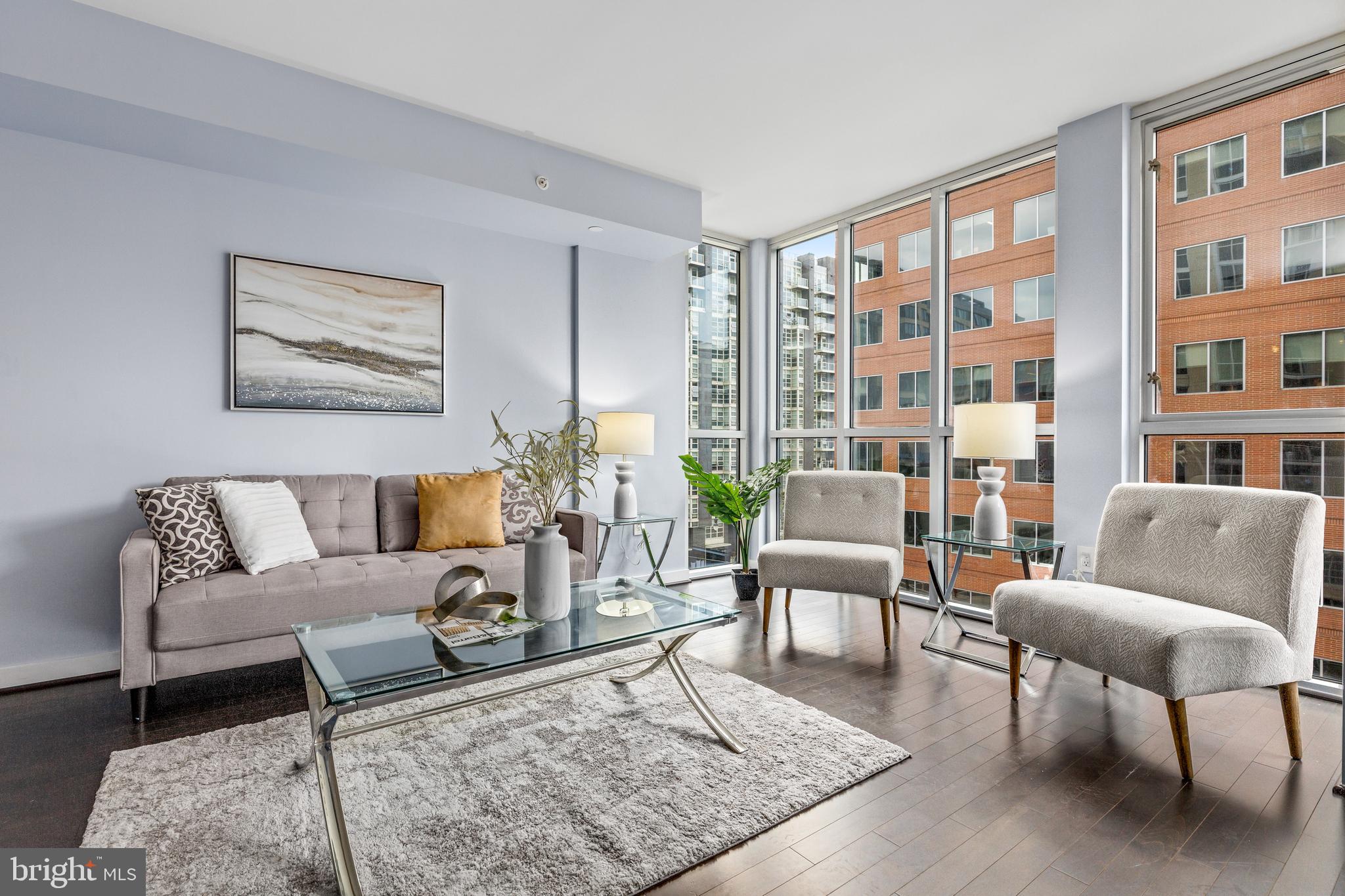 a living room with furniture and a book shelf
