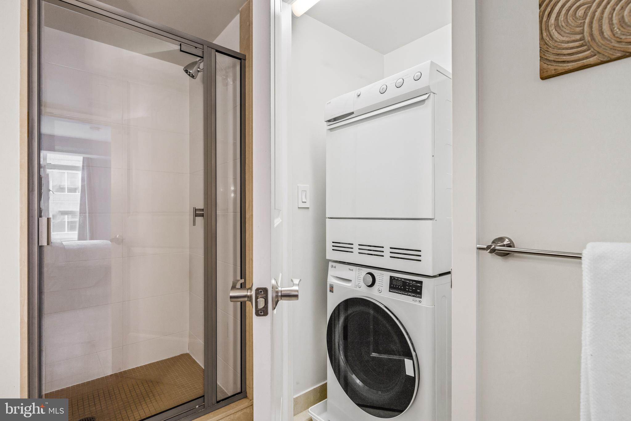 1025 First Street Southeast, Unit 611 Washington, DC 20003 - Photo 26 of 32 a view of a hallway with washer and dryer
