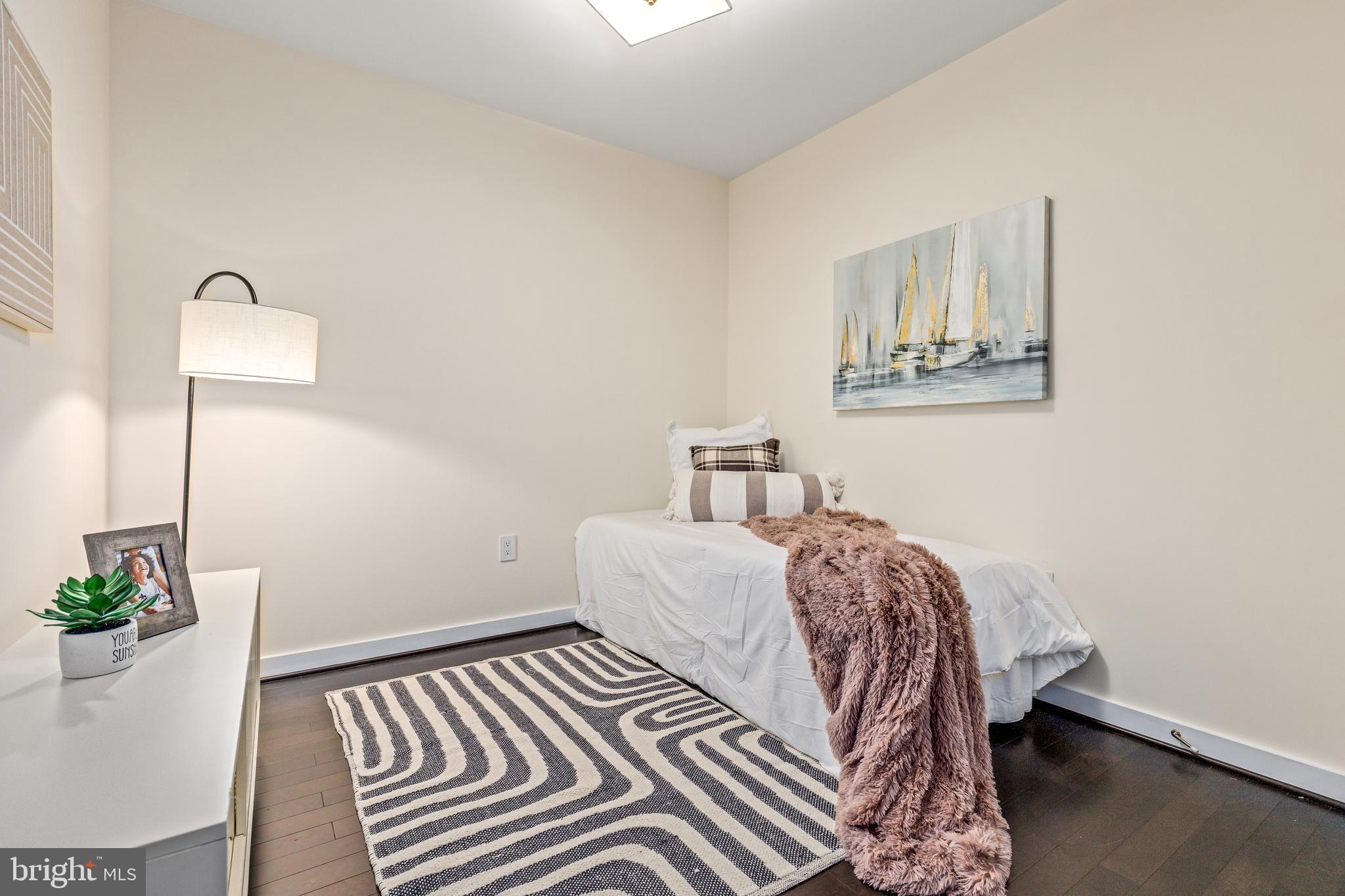 1025 First Street Southeast, Unit 611 Washington, DC 20003 - Photo 3 of 32 a bedroom with a bed and a table