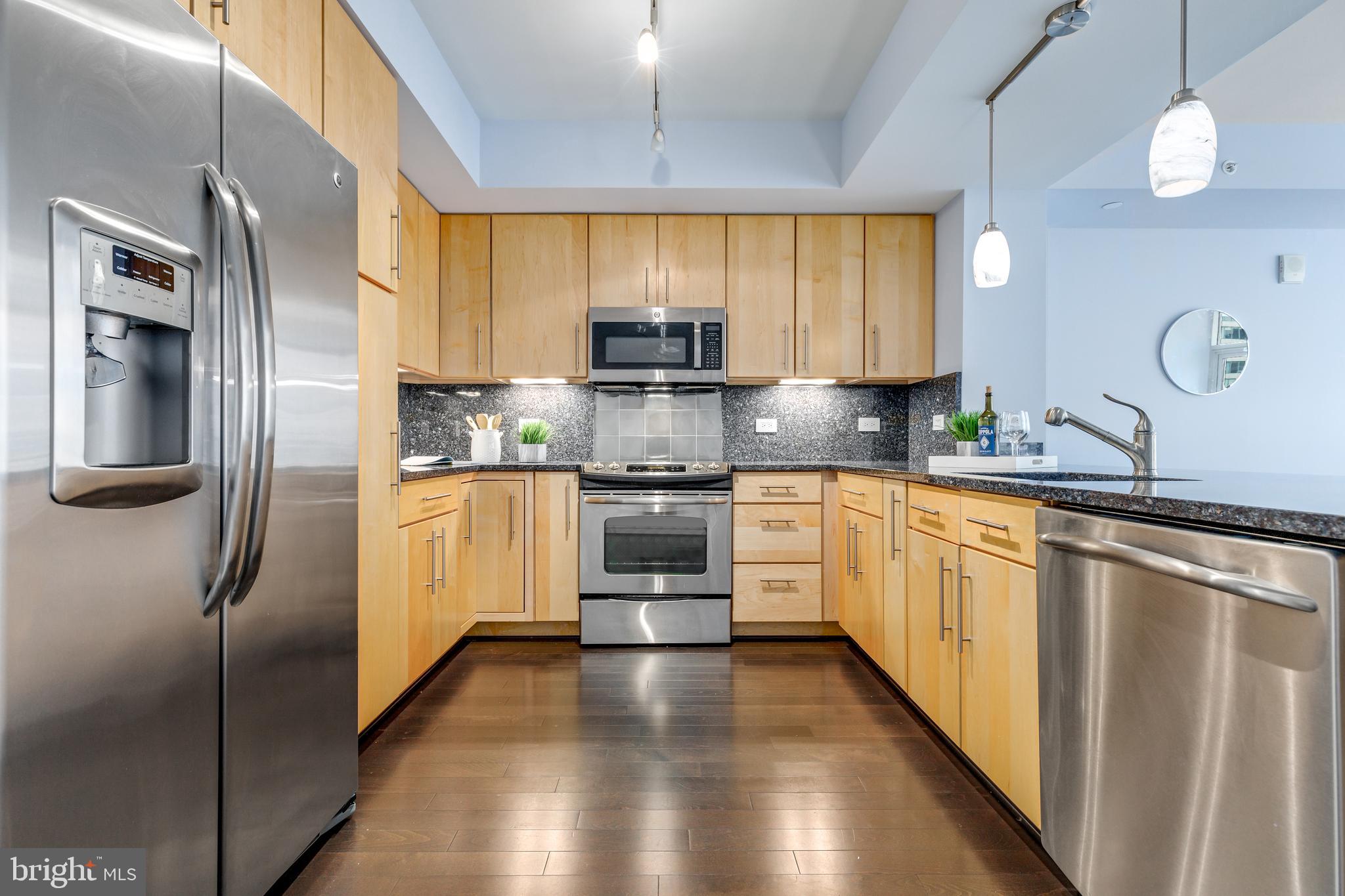 1025 First Street Southeast, Unit 611 Washington, DC 20003 - Photo 7 of 32 a kitchen with stainless steel appliances a refrigerator sink and cabinets