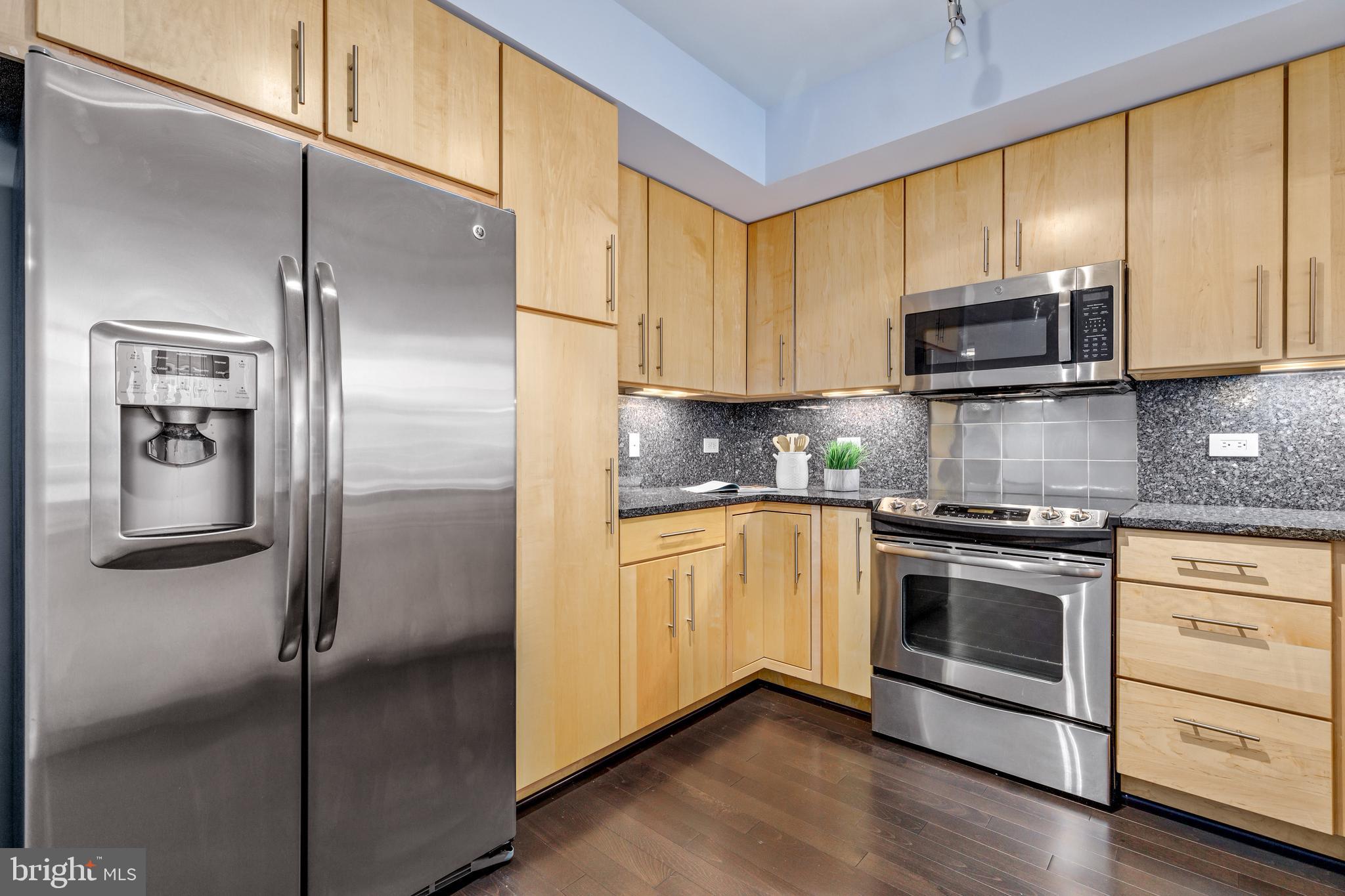 1025 First Street Southeast, Unit 611 Washington, DC 20003 - Photo 10 of 32 a kitchen with stainless steel appliances granite countertop a refrigerator and a stove