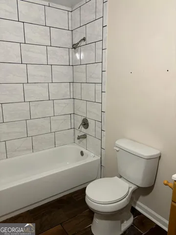 a bathroom with a toilet and a bathtub