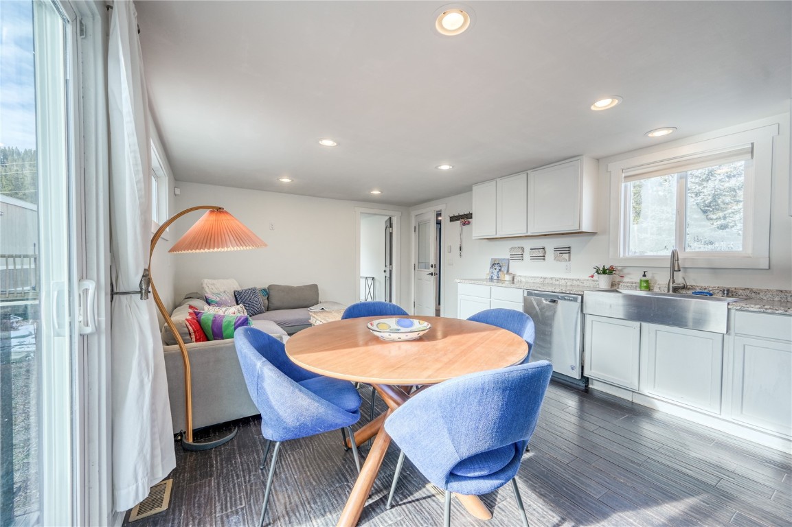 847 Airport Road, Unit 14 Breckenridge, CO 80424 - Photo 14 of 27 a kitchen with stainless steel appliances granite countertop a table chairs and a refrigerator