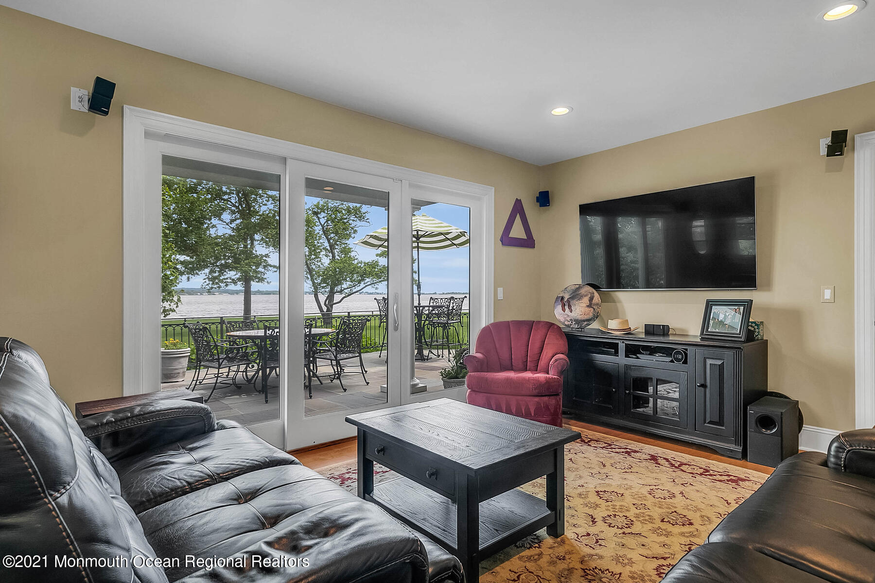 100 Goose Neck Point Road Oceanport, NJ 07757 - Photo 19 of 49 a living room with furniture a flat screen tv and floor to ceiling window