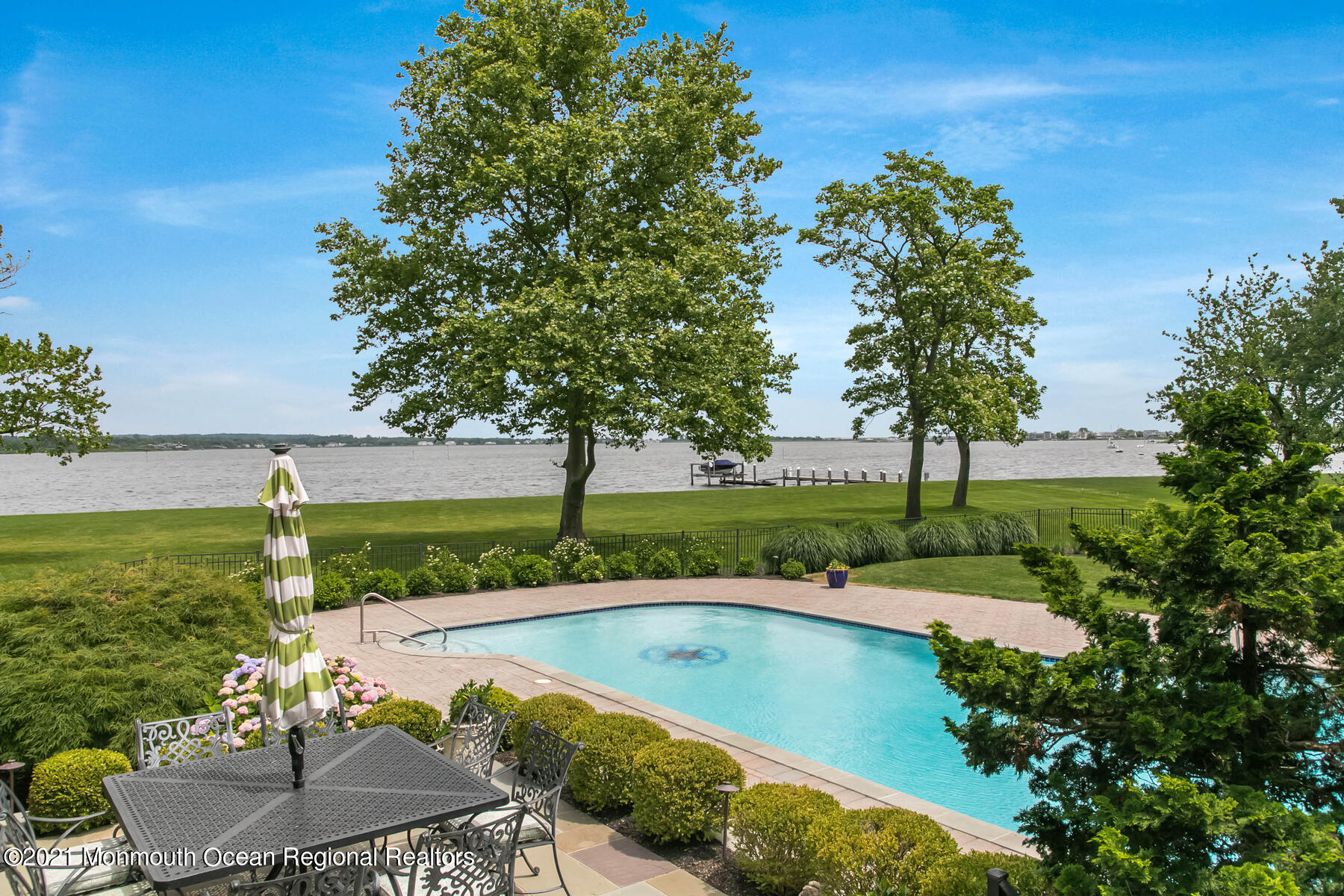100 Goose Neck Point Road Oceanport, NJ 07757 - Photo 33 of 49 a view of swimming pool with a garden and deck