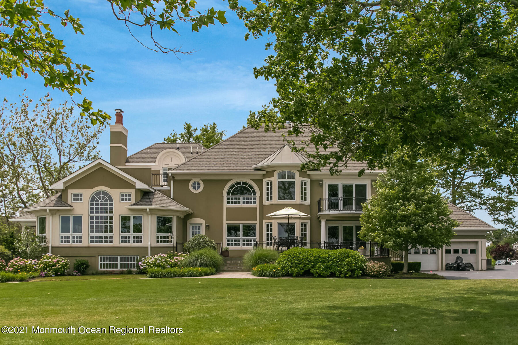 100 Goose Neck Point Road Oceanport, NJ 07757 - Photo 34 of 49 a front view of a house with a garden