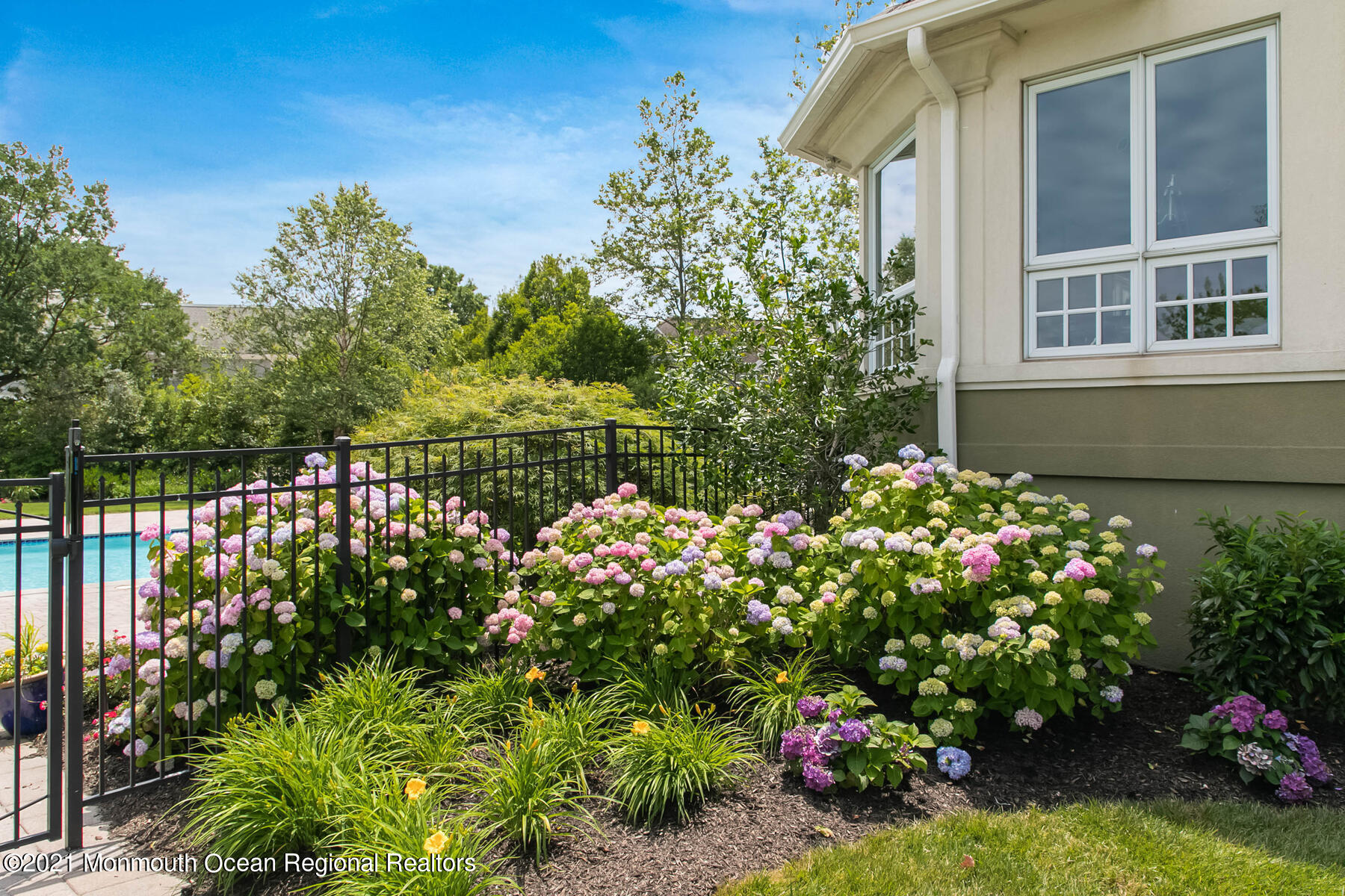 100 Goose Neck Point Road Oceanport, NJ 07757 - Photo 44 of 49 a bunch of flowers in front of yellow house
