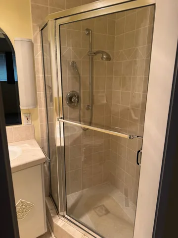 a bathroom with a shower and a sink