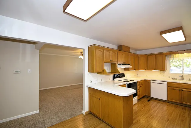 a kitchen with a sink appliances and cabinets
