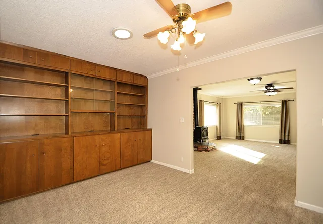 a view of a livingroom with a furniture and a ceiling fan