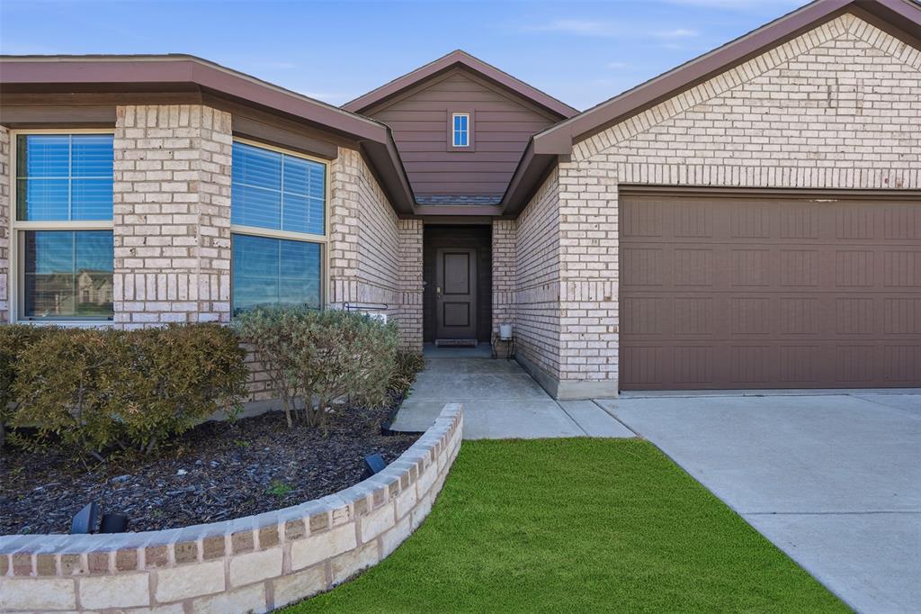 816 Durango Lane Cleburne, TX 76033 - Photo 2 of 16 a view of a house with a small yard and plants