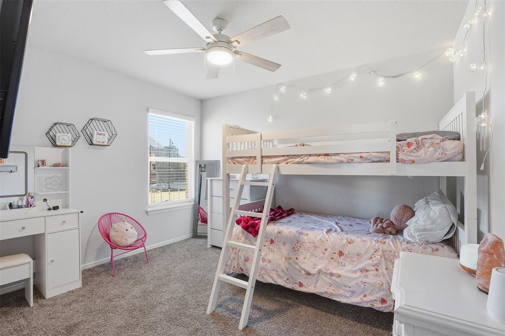 816 Durango Lane Cleburne, TX 76033 - Photo 10 of 16 a bedroom with a bed and a chandelier