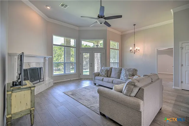 a living room with furniture fireplace and flat screen tv