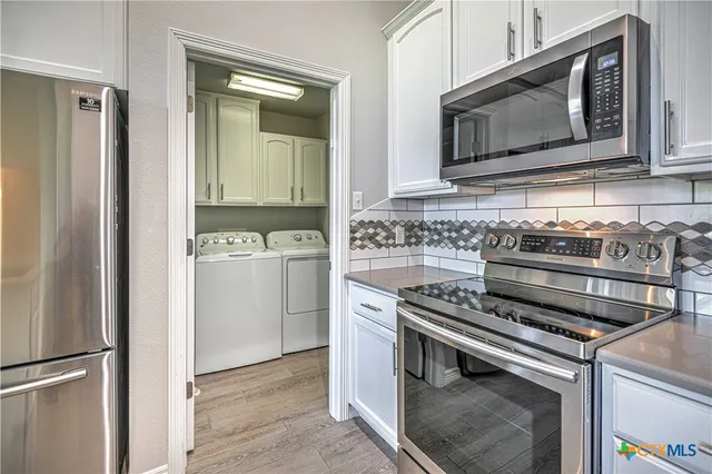 a kitchen with a stove microwave and refrigerator