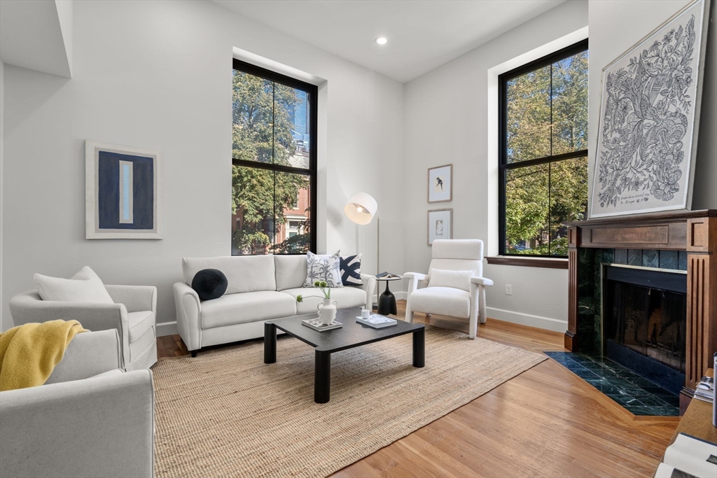 a living room with furniture fireplace and window