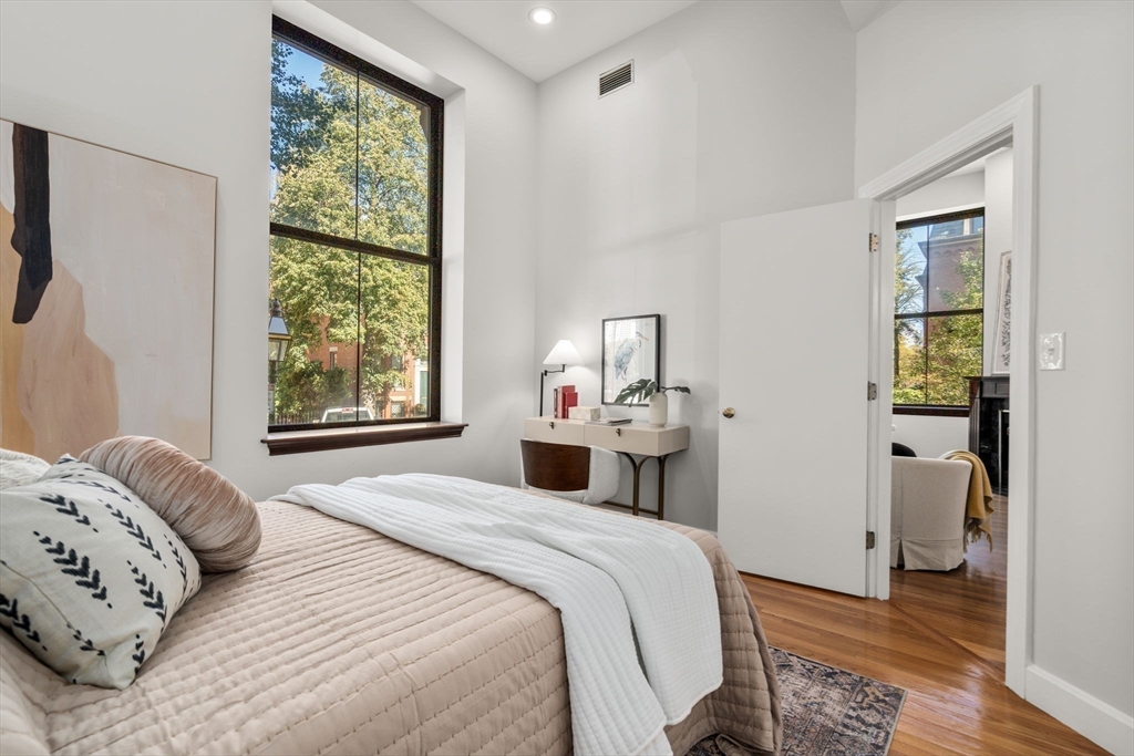 150 Appleton Street, Unit 2A Boston, MA 02116 - Photo 12 of 24 a bedroom with a bed a dresser and a window