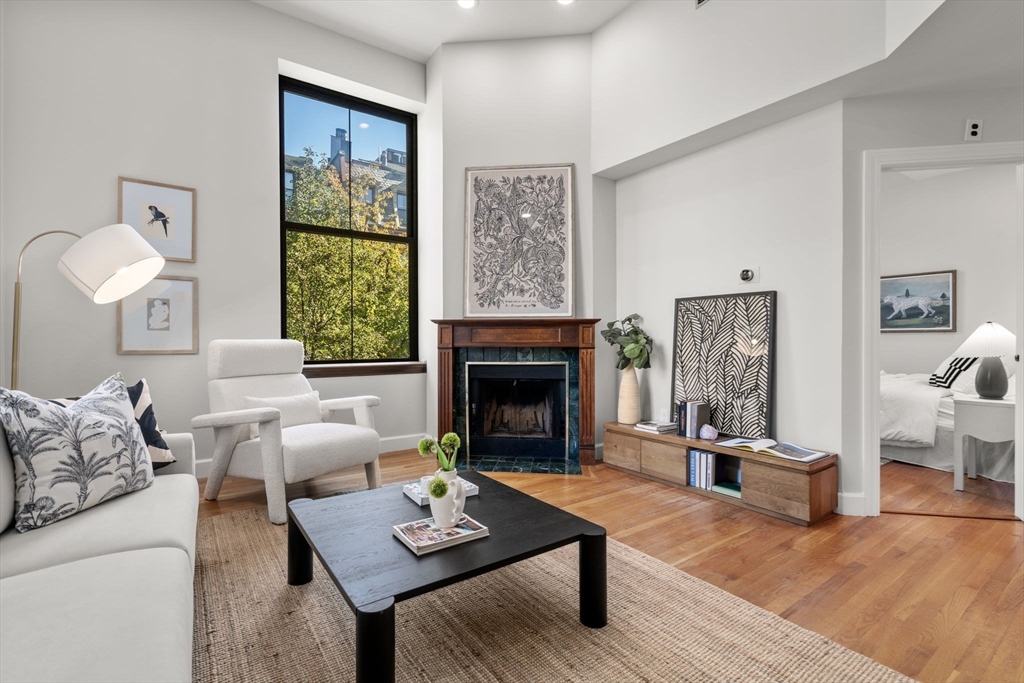 150 Appleton Street, Unit 2A Boston, MA 02116 - Photo 2 of 24 a living room with furniture and a fireplace
