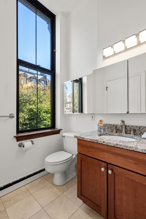 150 Appleton Street, Unit 2A Boston, MA 02116 - Photo 10 of 24 a bathroom with a granite countertop sink mirror vanity and toilet