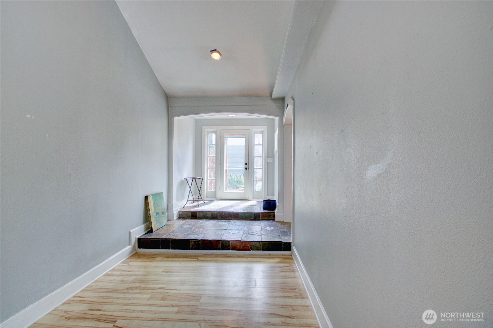 818 Serene View Road Camano Island, WA 98282 - Photo 12 of 39 a view of an empty room with wooden floor and a window