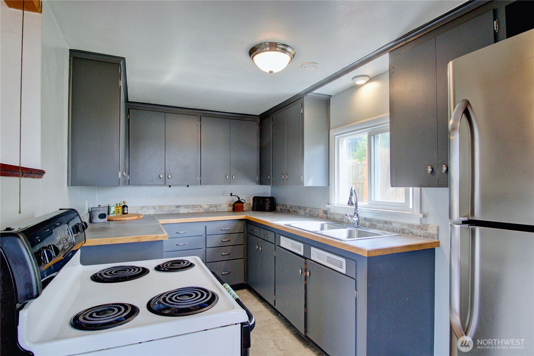 818 Serene View Road Camano Island, WA 98282 - Photo 18 of 39 a kitchen with a sink a stove and refrigerator
