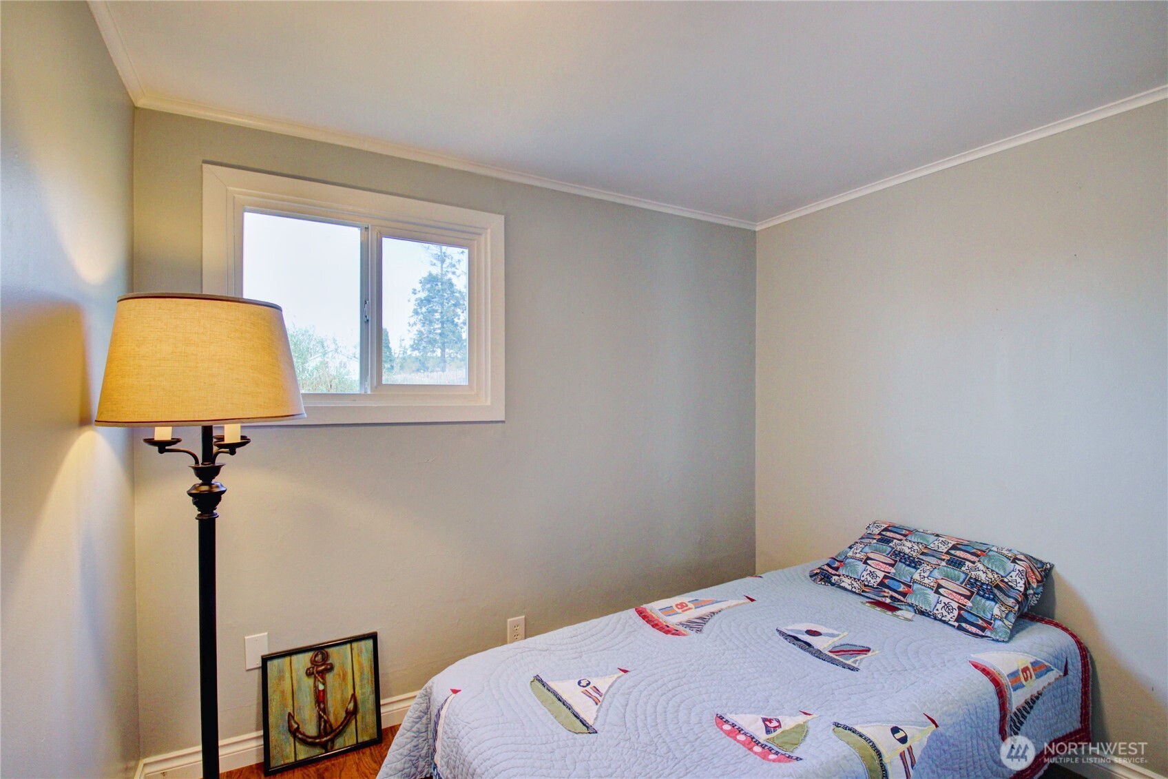 818 Serene View Road Camano Island, WA 98282 - Photo 26 of 39 a bedroom with a bed a dresser and a window