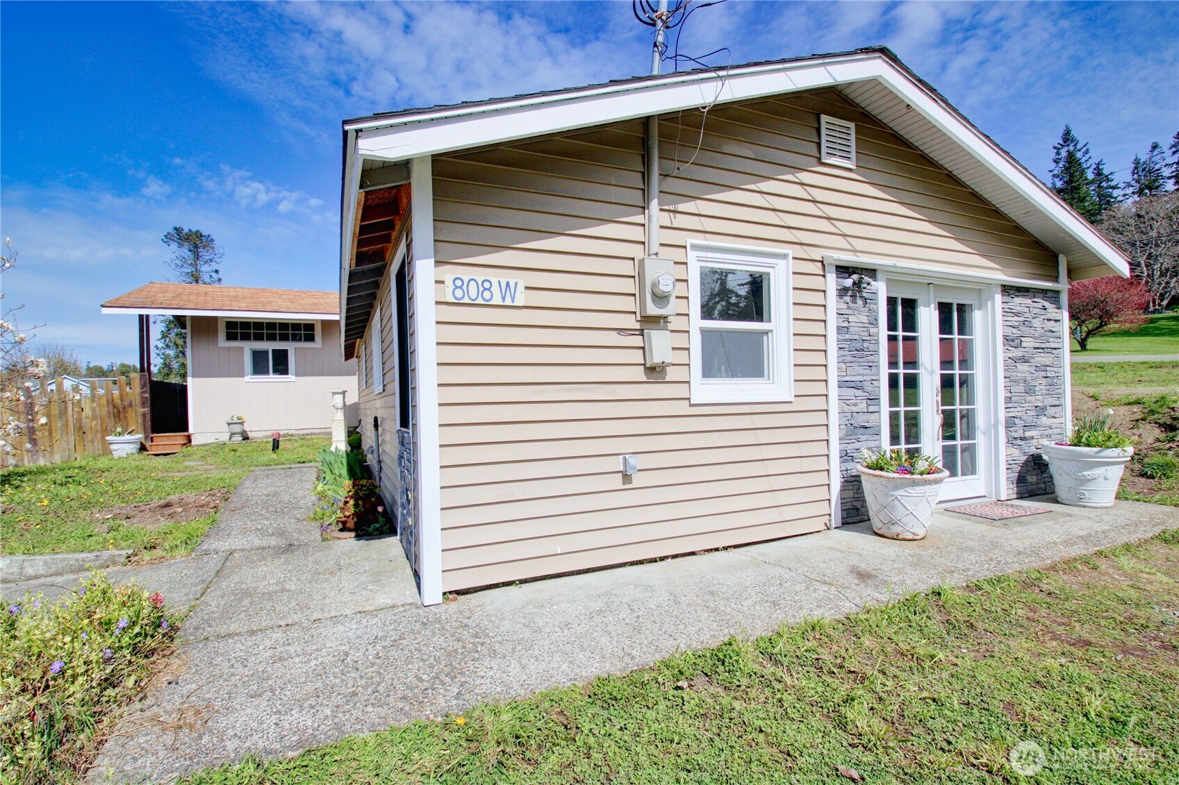 818 Serene View Road Camano Island, WA 98282 - Photo 3 of 39 a front view of a house with a yard