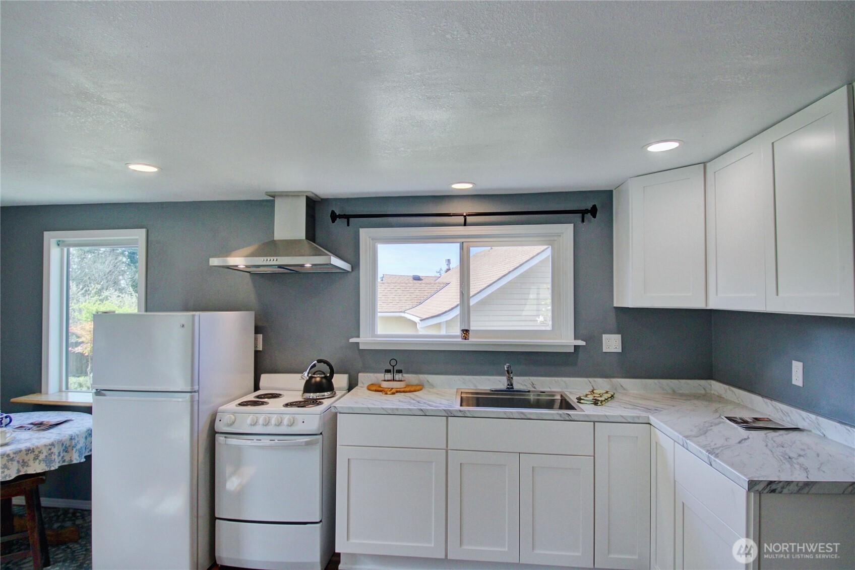 818 Serene View Road Camano Island, WA 98282 - Photo 34 of 39 a kitchen with a sink a refrigerator and cabinets
