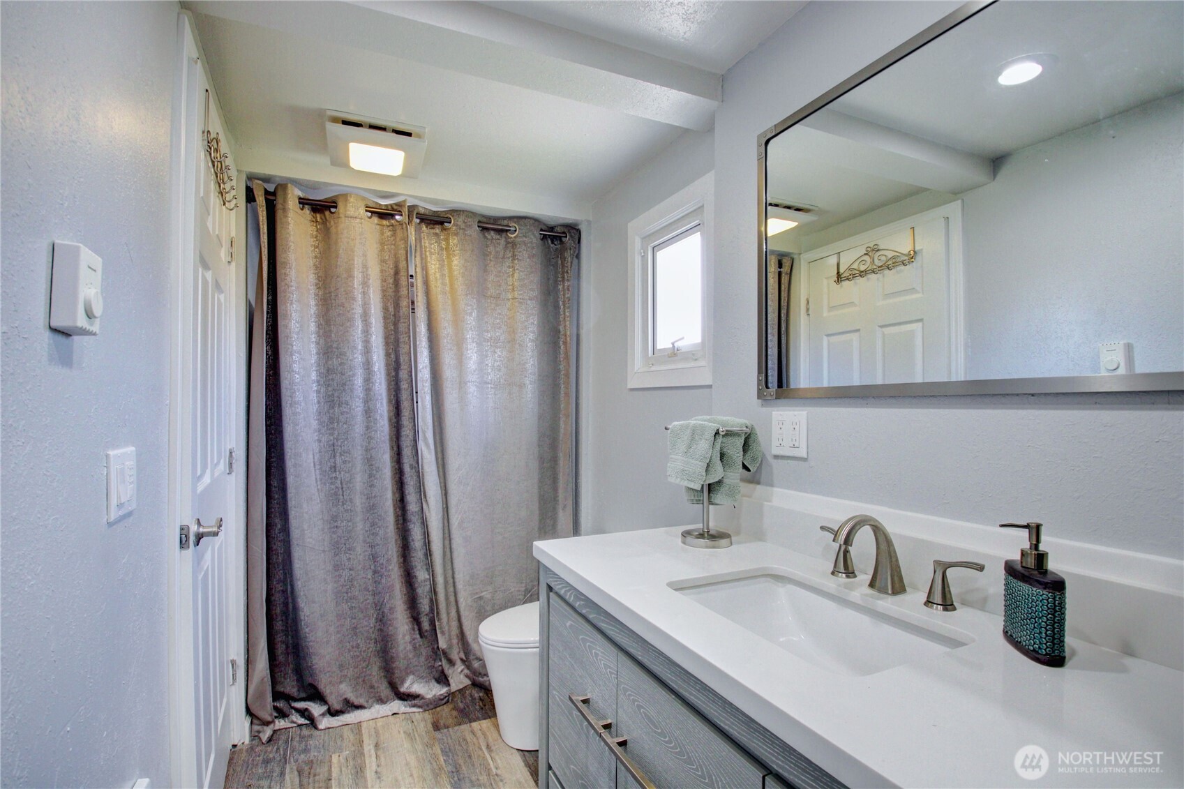 818 Serene View Road Camano Island, WA 98282 - Photo 36 of 39 a bathroom with a sink a mirror and a shower