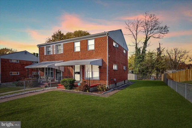 a front view of a house with a yard table and chairs