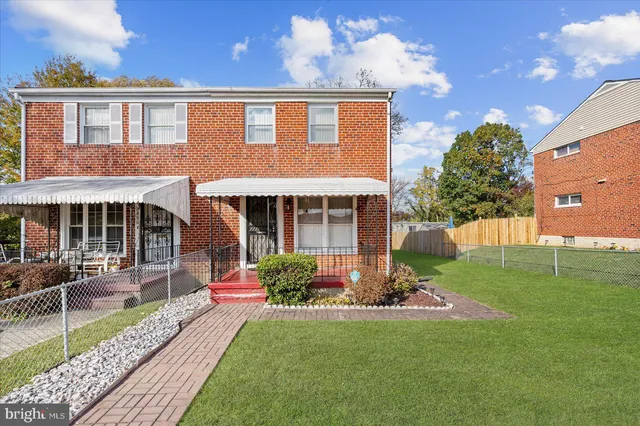 a front view of a house with a yard table and chairs