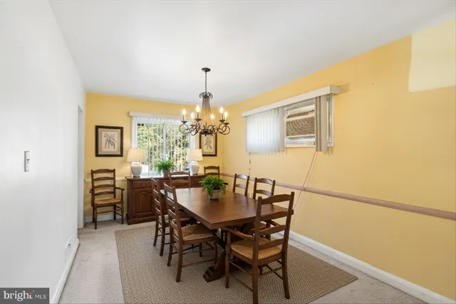 a view of a dining room with furniture and chandelier