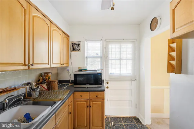 a kitchen with stainless steel appliances a sink a stove and a window