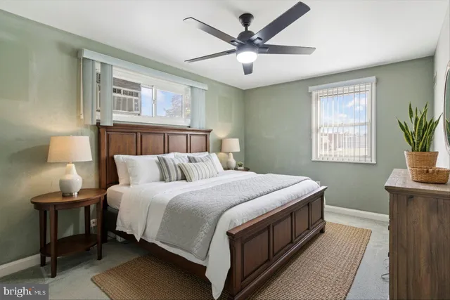 a bed room with a bed a chandelier and a window