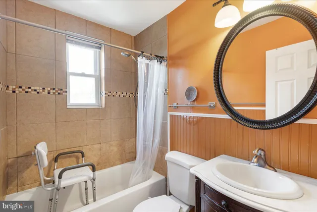 a bathroom with a sink a toilet and a mirror