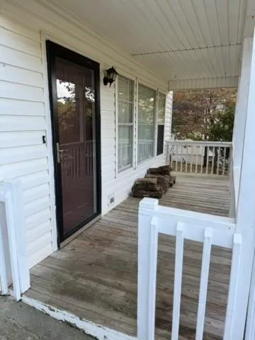 a living room with a bed and large window