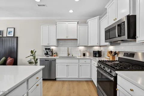 a living room with furniture a window and a flat screen tv
