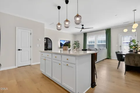 a kitchen with cabinets stainless steel appliances and wooden floor