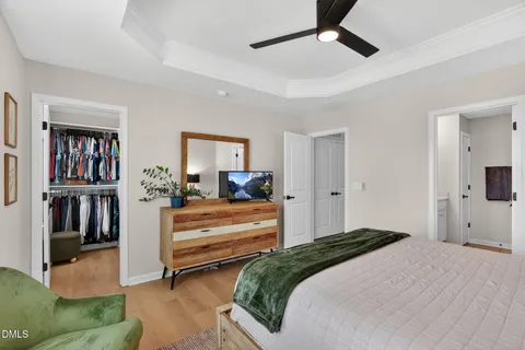 a bedroom with a bed a couch and a window