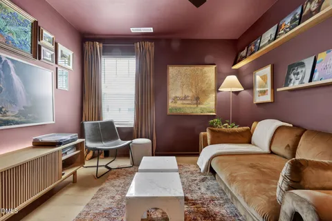 a view of a hallway with furniture and a potted plant