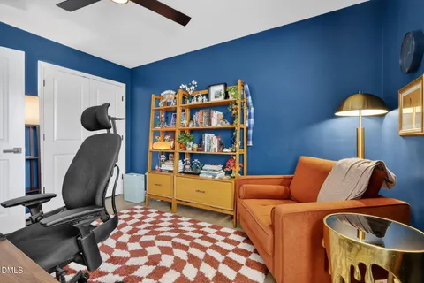 a bedroom with furniture and a book shelf