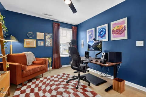 a living room with furniture and a lamp