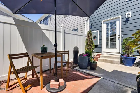 a view of a chairs and table in patio