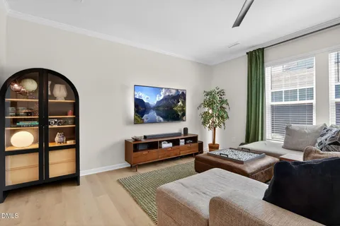 a living room with kitchen island furniture and a chandelier