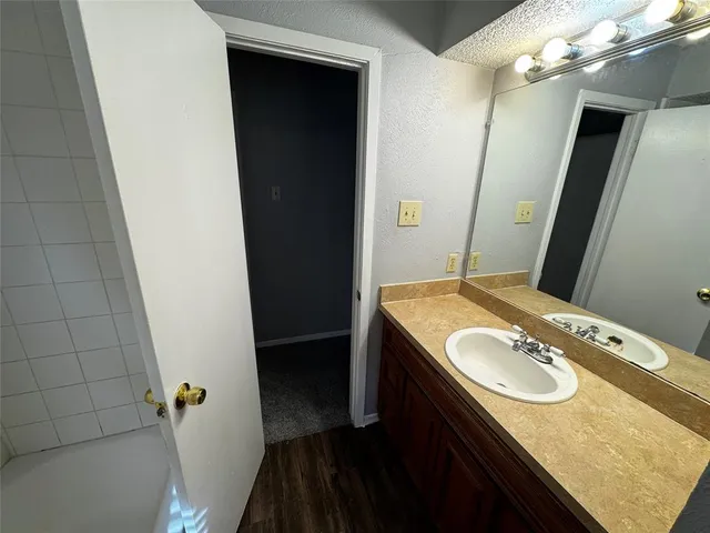 an empty room with windows and a ceiling fan