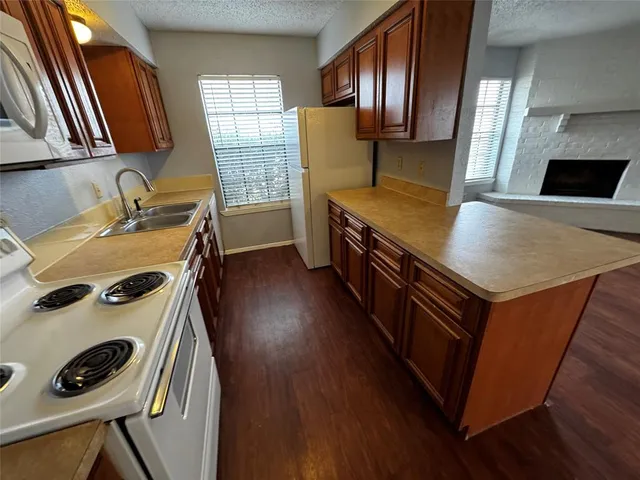 a kitchen with a stove a sink and a refrigerator