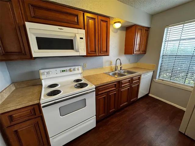 a kitchen with stainless steel appliances a stove microwave and cabinets
