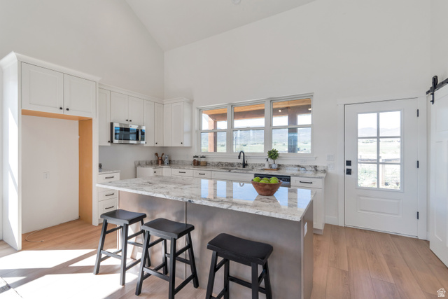 1820 West Farmhouse Flats Road Peoa, UT 84061 - Photo 66 of 79 Kitchen featuring a vaulted ceiling and light wood-finish flooring